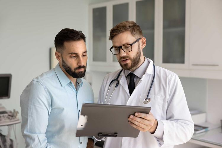 Bildnachweis: © stock.adobe.com / fizkes Arzt erklärt einem Patienten die Untersuchungserggebnisse